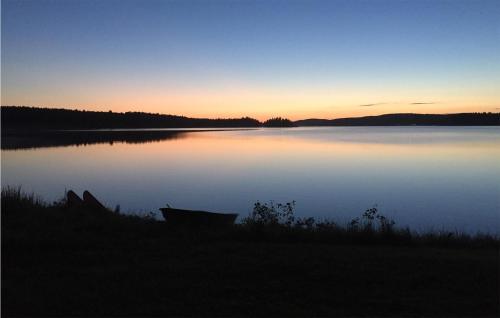 a view of a lake at sunset at Beach Front Home In Ludvika With Sauna in Ludvika