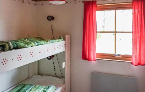 a bedroom with a bunk bed and a window at Beach Front Home In Ludvika With Sauna in Ludvika