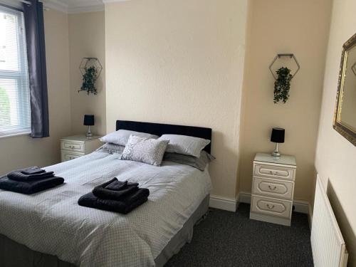 a bedroom with a bed with towels on it at RUDGRAVE SQUARE WALLASEY in Wallasey