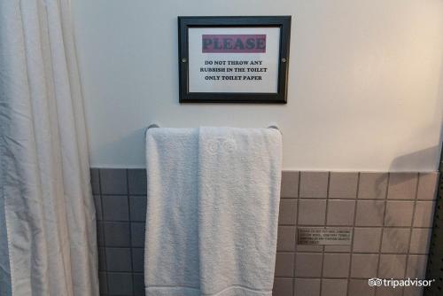 a bathroom with a towel and a picture on the wall at 101 Guesthouse Hotel in Reykjavík