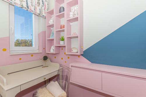 a pink bathroom with a tub and a window at Villa Romansa Miljevci near Krka National Park in Širitovci