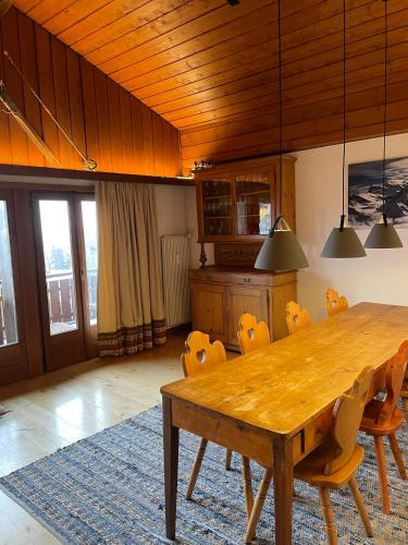 a dining room with a wooden table and chairs at Penthouse - Ski-in Ski-out 30 meters from Medran lift and 40 meters from W Hotel in Verbier
