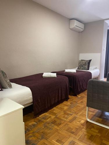 Кровать или кровати в номере Somnio Hostels