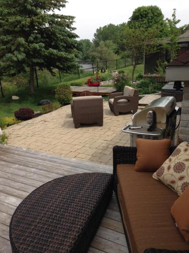 a patio with couches and a table and chairs at Cozy Luxury on the Thames in Ontario! in London