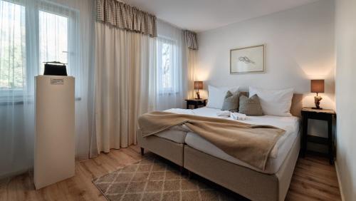 a bedroom with a large bed and a large window at Gasthof Badl - Bed & Breakfast in Hall in Tirol