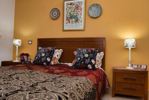 a bedroom with a bed with two night stands and two lamps at Dar Marrakech Apartment Sousse in Hammam Sousse