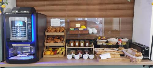 a grocery store with a display of bread and fruit at Hotel Parisien in Menton