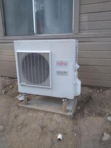 a white air conditioner sitting outside of a house at Julian House of Games in Julian