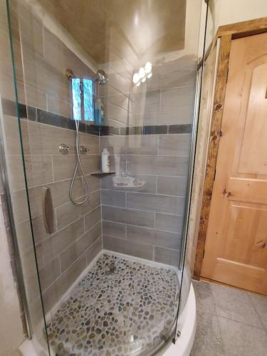 a bathroom with a shower with a glass shower stall at Julian House of Games in Julian
