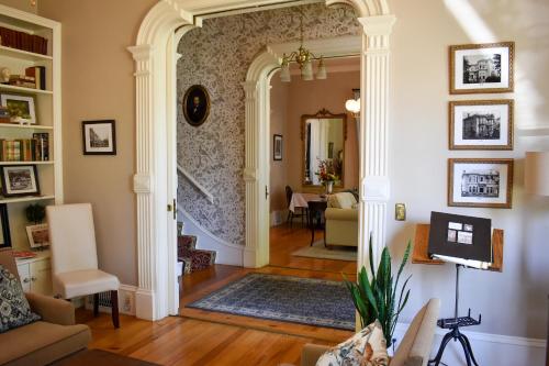 a living room with an archway leading to a dining room at McCall House Boutique Hotel in Ashland