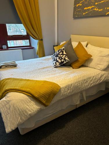 a bed with pillows on it in a bedroom at Mustard Seed 43 Seamore Street 1/L Largs in Largs