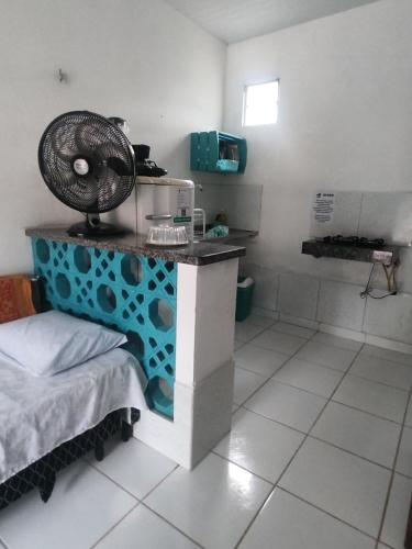 a room with a table with a fan on it at Hospedagens Icapui Mare Blu in Icapuí