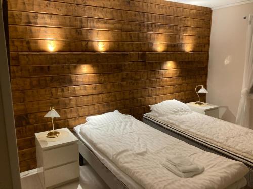 a bedroom with two beds and two night stands at Furudals Bruk in Furudals Bruk