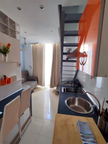 a small kitchen with a sink and a ladder at Apartamentos Marques De La Merced in Málaga