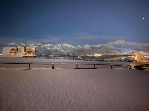 a view of a snowy mountain range at night at SOPA Zakopane in Zakopane