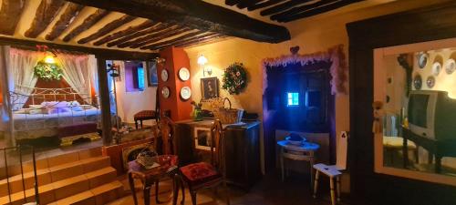a room with a bedroom with a bed and a table at La Quinta rural in Valeria