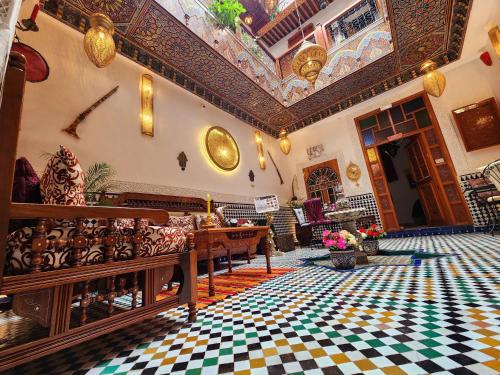 a large room with a ceiling and a floor with tiles at Riad Dar Kassim in Fez