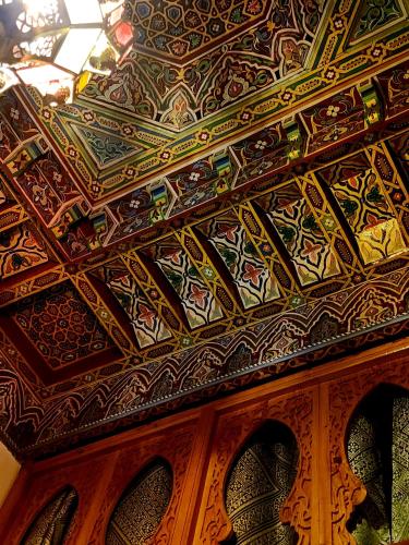 a room with a ceiling with intricate designs on it at Riad Dar Kassim in Fès
