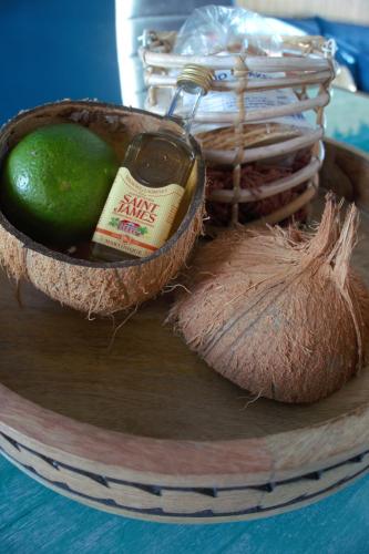 a basket of food with a bottle and a lime at Le Blue CoCo - 1 minute de la plage in Sainte-Anne