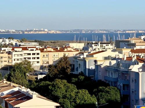a view of a city with white buildings and the water at Villa Hermano with views and private pool in Lagos
