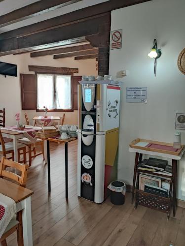 a room with a large refrigerator and a table at Pasaje San Jorge in Comillas