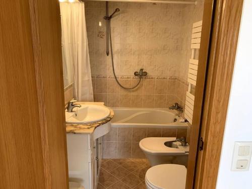 a bathroom with a sink and a tub and a toilet at Villa Hermano with views and private pool in Lagos