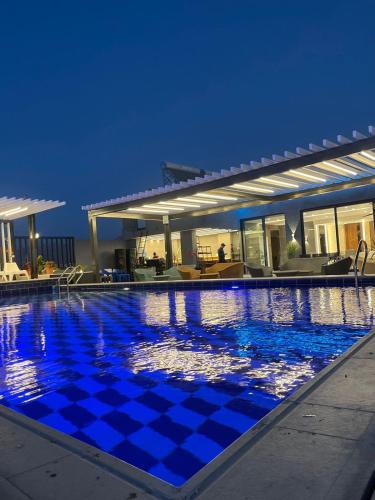 a large swimming pool with a blue at Mass Paradise Hotel in Aqaba