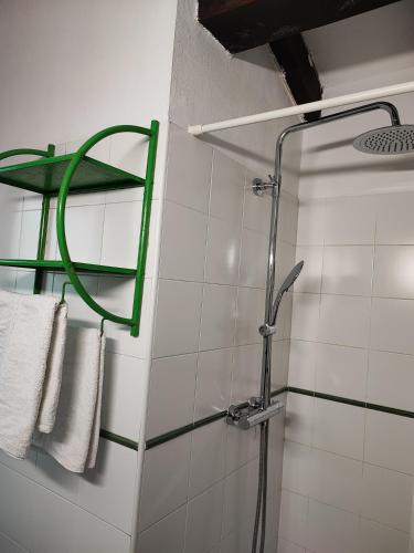 a bathroom with a shower with towels on a wall at Pasaje San Jorge in Comillas