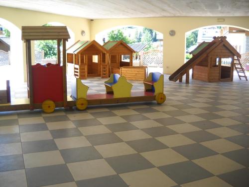 a play room with a train on a checkered floor at Casa Fior del Soreie in Pozza di Fassa