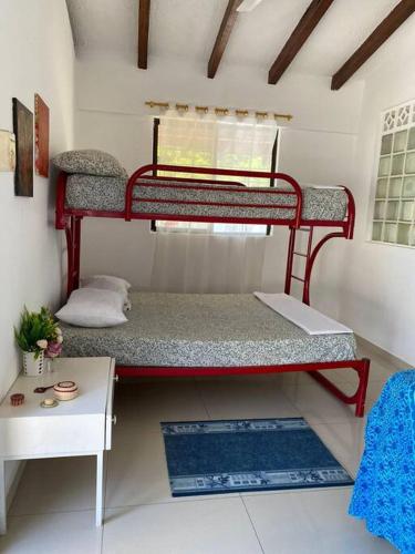 a toy room with two bunk beds and a table at Casa Albatros (Playa-Esmeraldas) in Tonsupa