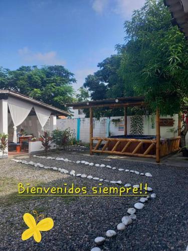 a picture of a house with a yellow flower on the ground at Casa Albatros (Playa-Esmeraldas) in Tonsupa