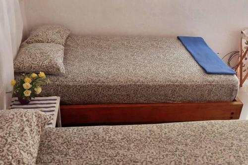 a bedroom with two beds and a blue pillow at Casa Albatros (Playa-Esmeraldas) in Tonsupa