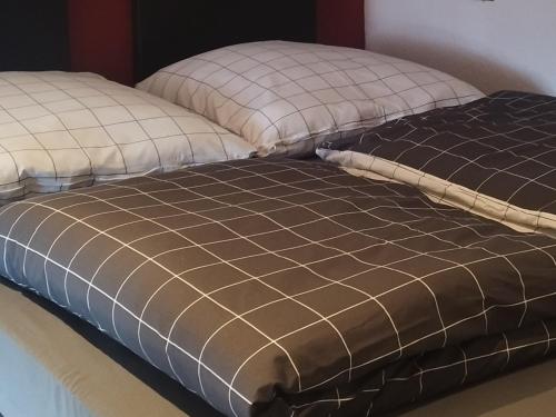 a bed with two pillows on top of it at Ferienwohnung am Niederrhein in Kevelaer