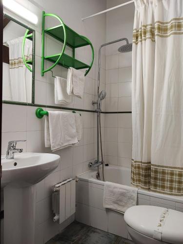 a bathroom with a sink and a toilet and a shower at Pasaje San Jorge in Comillas