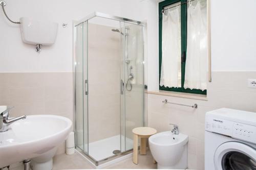 a bathroom with a shower and a sink and a toilet at Villa Tramonto in Alghero