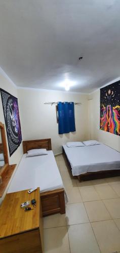 two beds in a room with blue towels on the wall at Dahab house Studio in Dahab