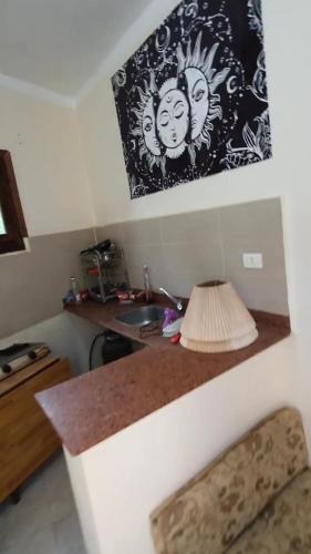 a kitchen with a counter with a sink and a lamp at Dahab house Studio in Dahab