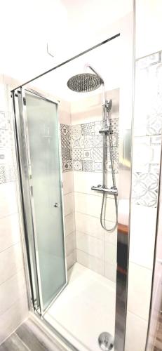 a shower with a glass door in a bathroom at B & B LuVì in Vibo Valentia
