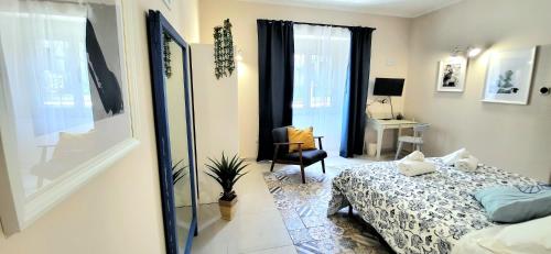 a bedroom with a bed and a chair in a room at B & B LuVì in Vibo Valentia