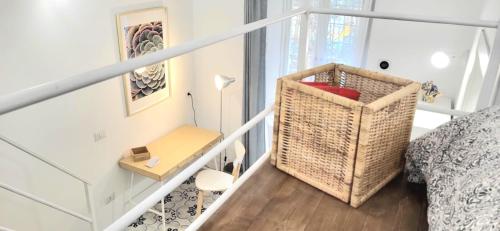a small white room with a bed and a table at B & B LuVì in Vibo Valentia