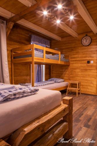 a bedroom with two bunk beds in a cabin at Penzion Kera in Rossitz