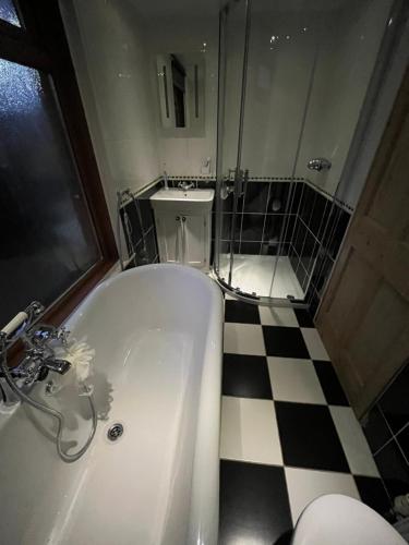 a bathroom with a shower and a tub and a toilet at Ivanhoe Home from Home in Freshwater