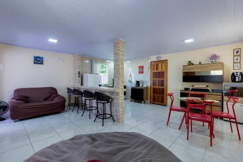 a living room with a couch and a table and chairs at Sobrado da Vila, 1km Centro, ideal Trabalho e Passeio in Morretes