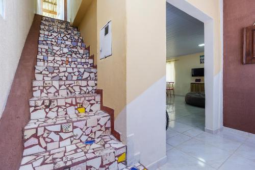 a staircase in a house with mosaic tiles on it at Sobrado da Vila, 1km Centro, ideal Trabalho e Passeio in Morretes
