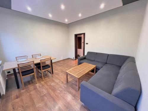 a living room with a couch and a table at 2-room apartment in the city center in Poznań