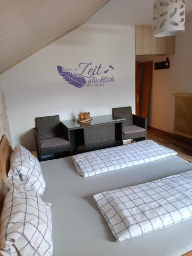 a living room with two beds and a table at Frühstückspension Lemberger in Dellach im Drautal