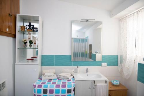 a bathroom with a sink and a mirror at La casa dei nonni in Paola