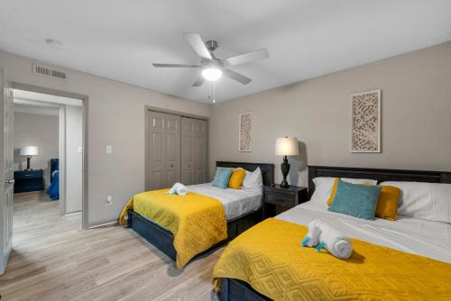 a bedroom with two beds and a ceiling fan at Truist Park Comfort Stays in Atlanta