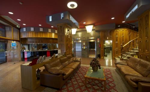 a large living room with couches and a rug at Hotel Francisco II in Ourense