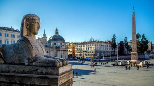 a statue in a square in a city at Palazzo Venere in Rome